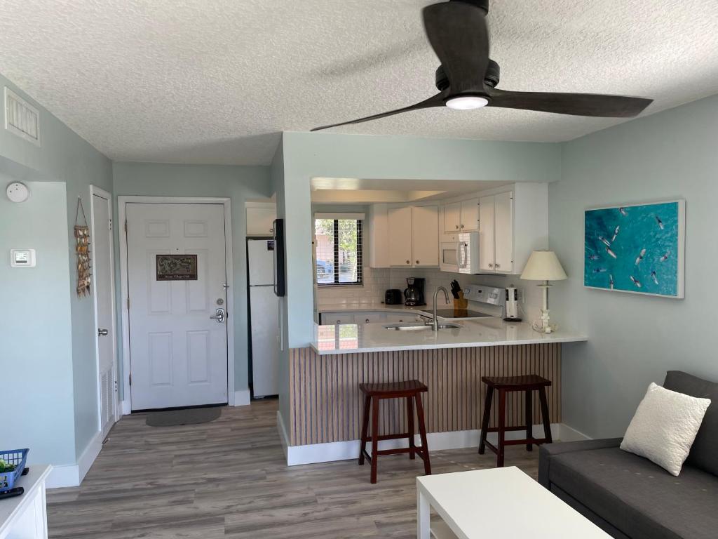 a living room with a couch and a kitchen at Ocean Village Club in Saint Augustine
