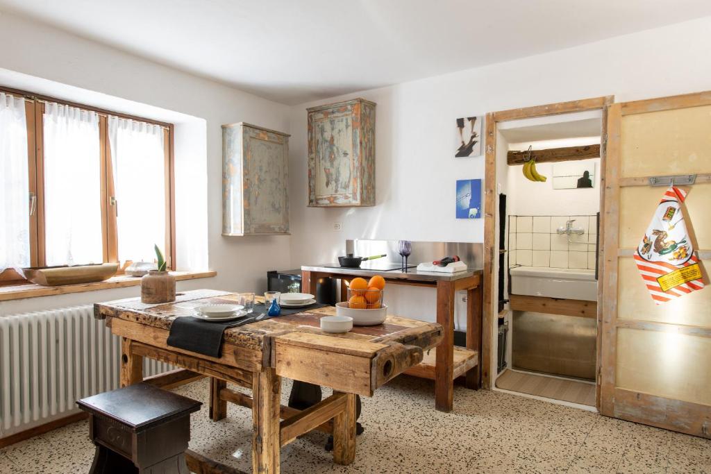 a kitchen with a wooden table in a room at Casa Vacanze Zummer Frei Studio in Pieve di Cadore