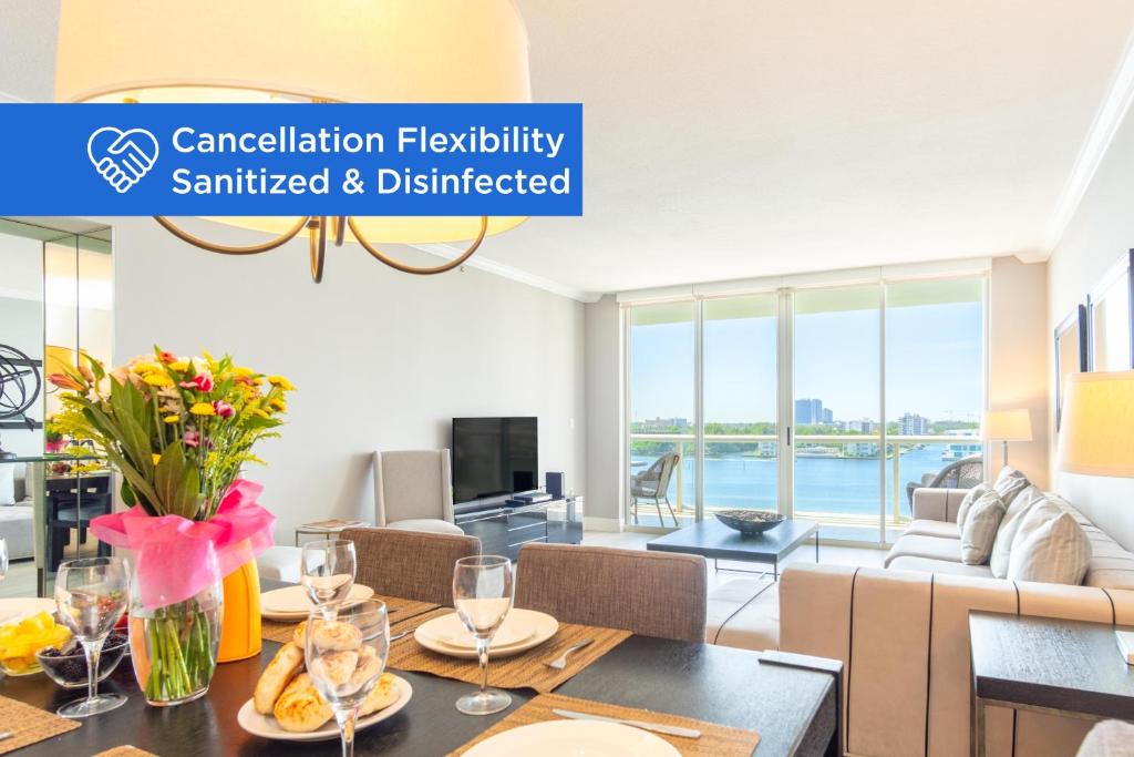 a living room with a table and chairs and a couch at Golden Bay 808 in Miami Beach