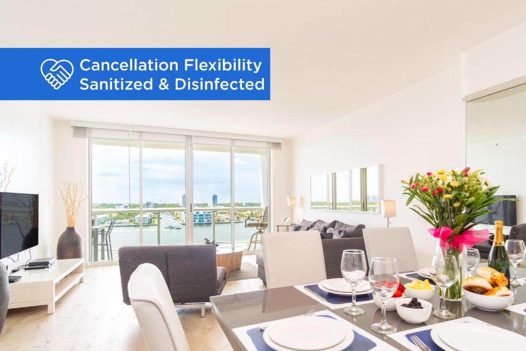 a dining room and living room with a table and chairs at Golden Bay 1003 in Miami Beach