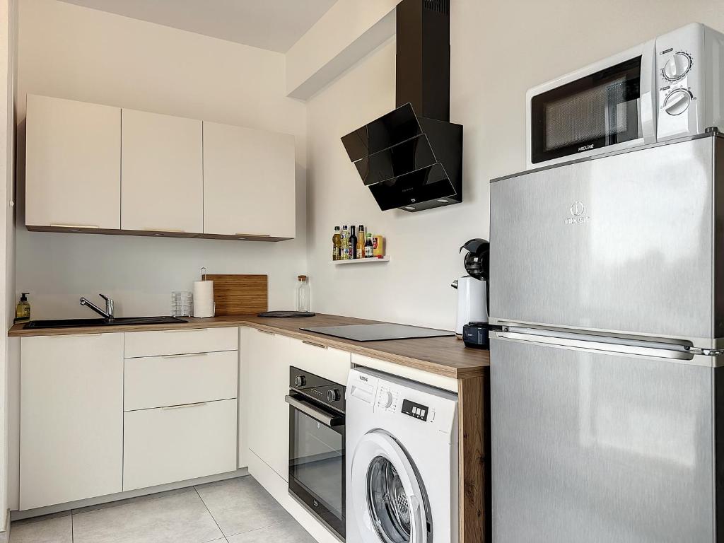 Kuchyň nebo kuchyňský kout v ubytování Le 121 - Appartement 101