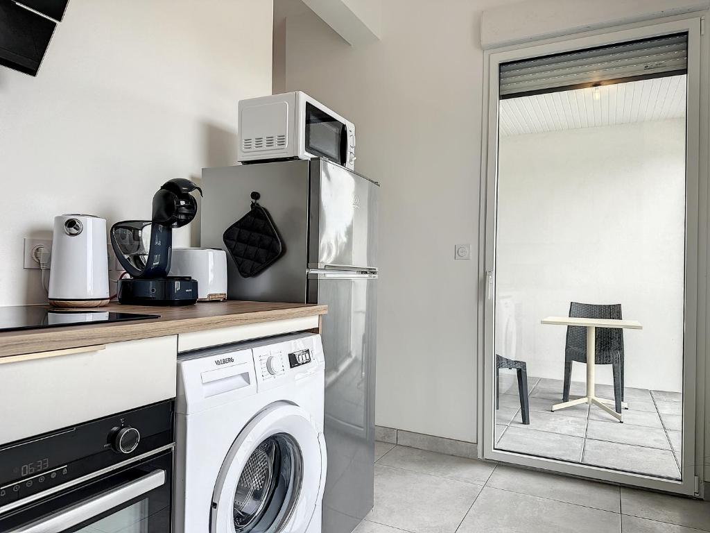 Kuchyň nebo kuchyňský kout v ubytování Le 121 - Appartement 101
