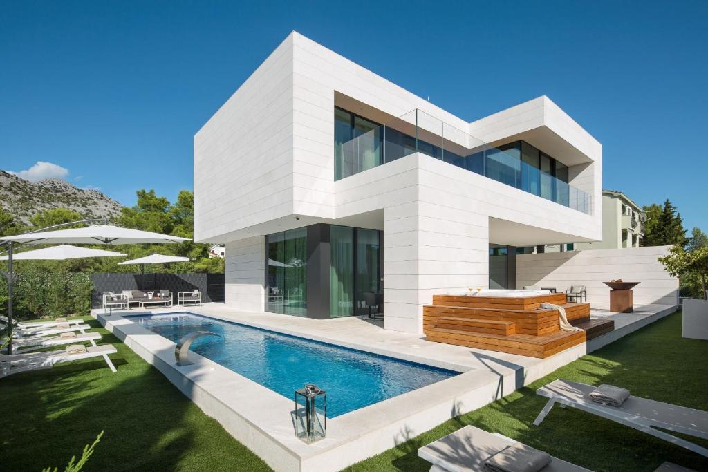 a large white house with a swimming pool at Calma Ii in Starigrad