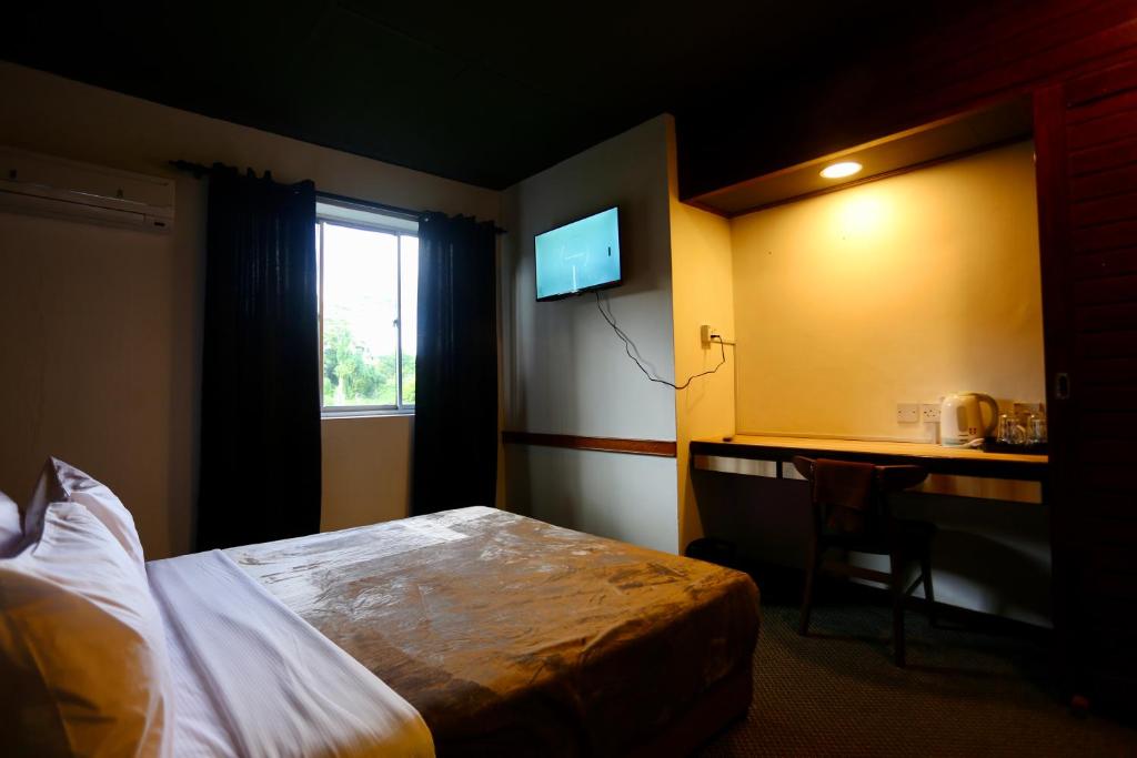 Postel nebo postele na pokoji v ubytování Fata Hotel by Project Borneo