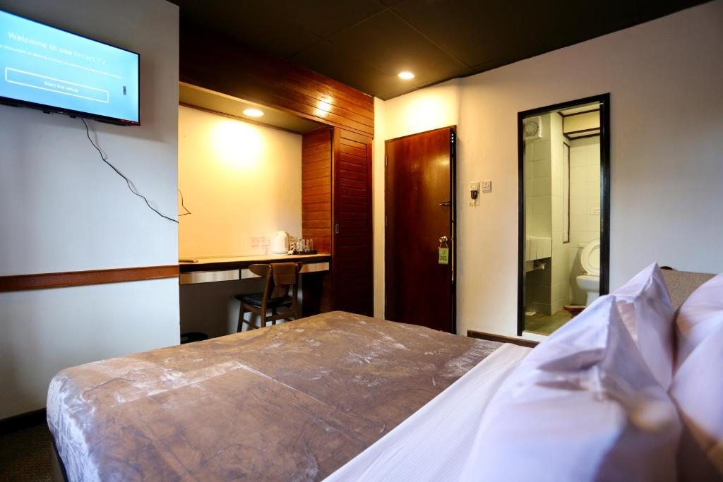 Postel nebo postele na pokoji v ubytování Fata Hotel by Project Borneo