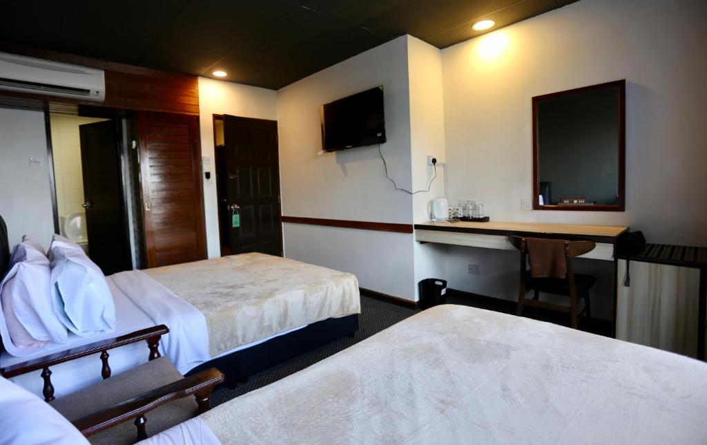 Postel nebo postele na pokoji v ubytování Fata Hotel by Project Borneo