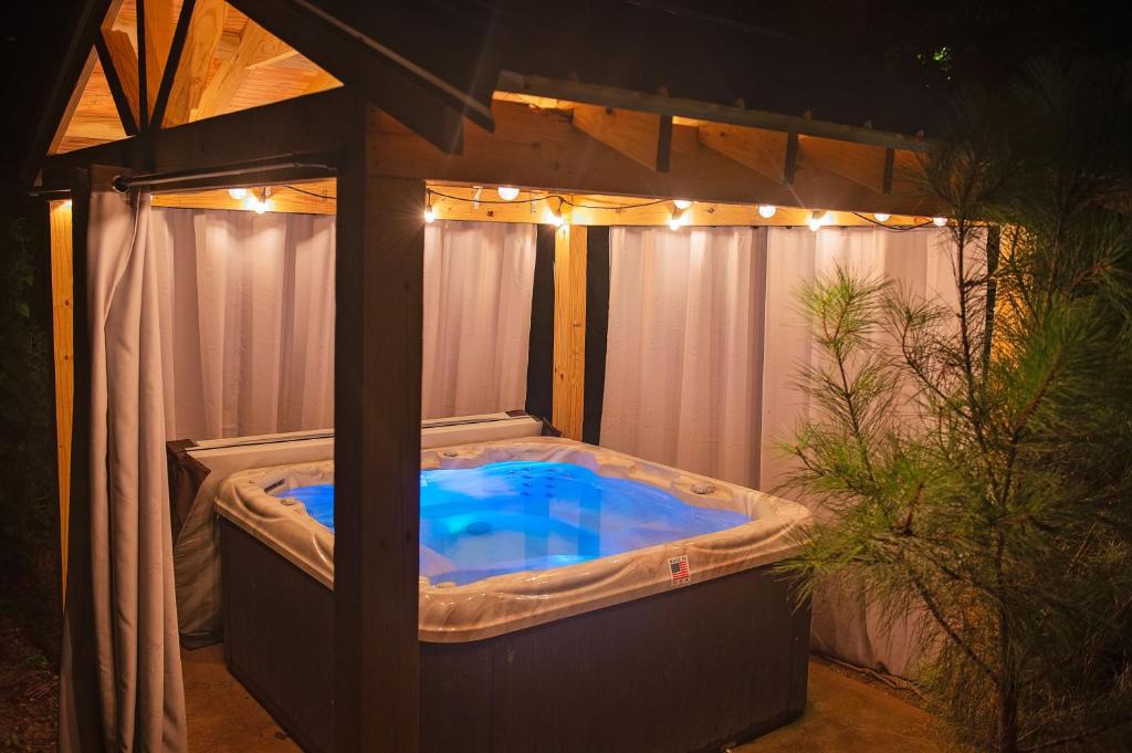 a hot tub in a gazebo with lights at Luke Cabin Escape To Our Luxury Hot Tub Cabin in Chattanooga