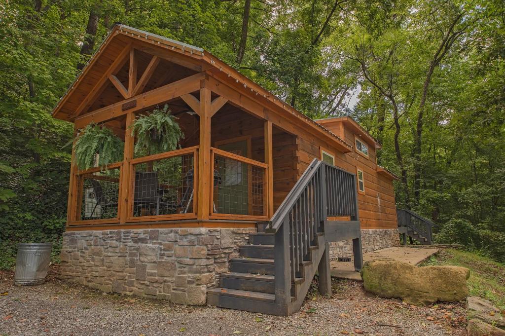 a cabin in the woods with a large window at Papa Cabin Tiny Log Home Comfort In Rustic Bliss in Chattanooga