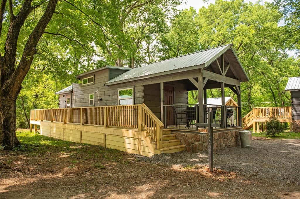 a cabin in the woods with a large deck at Maggie Cabin Enjoy Nature From A Forest Hot Tub in Chattanooga