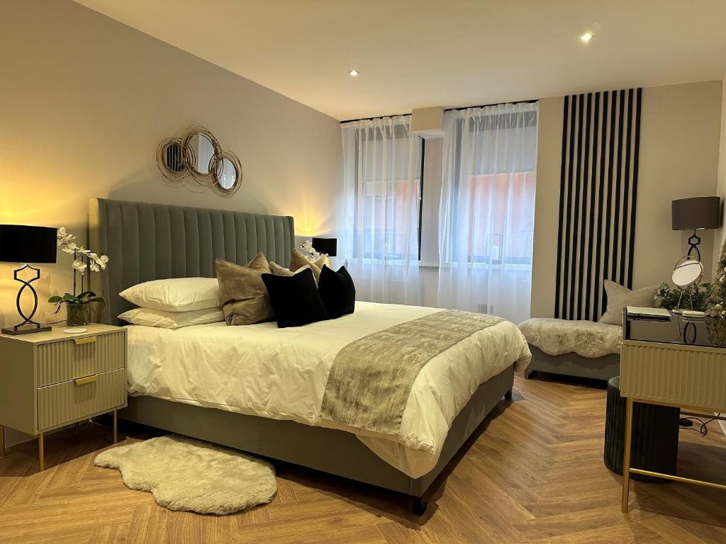 a bedroom with a large bed and a living room at Romantic Royal Windsor in Windsor