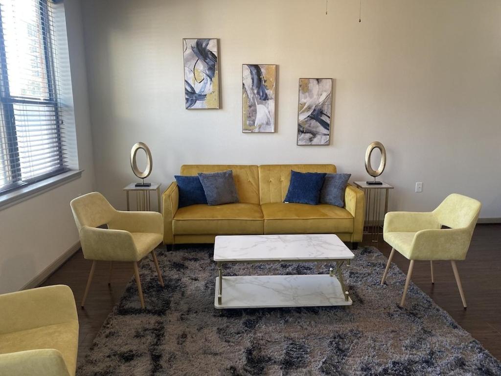 a living room with a couch and two chairs at Luxe Getaway Astros NRG Galleria in Houston