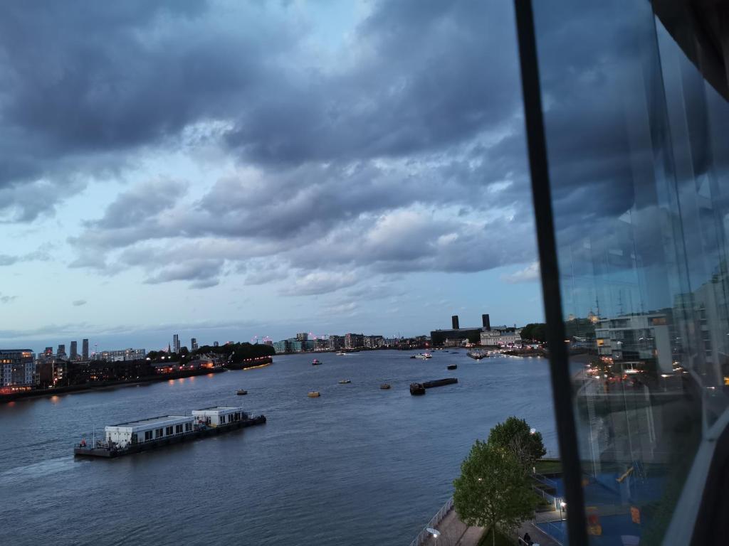 a view of a river with boats on it at Homestay Room in Apartment with Stunning Thames River View in London