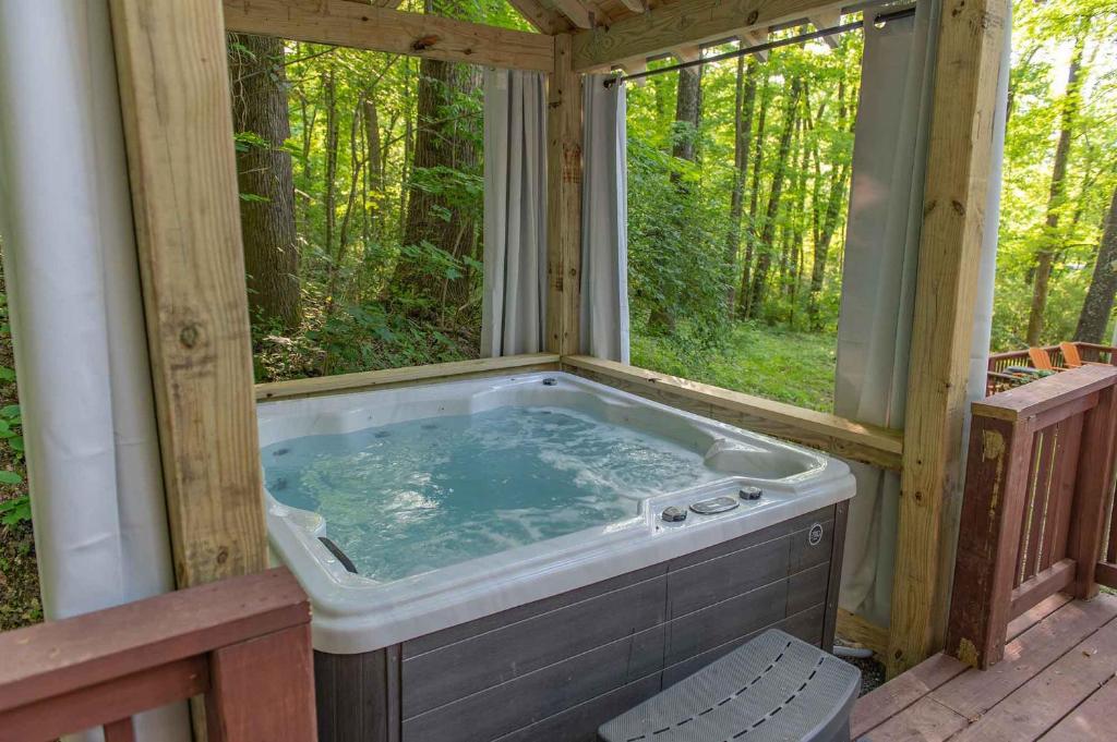 a soaking tub in a house with a window at Martha Cabin Tiny Cabin By Downtown Chattanooga in Chattanooga