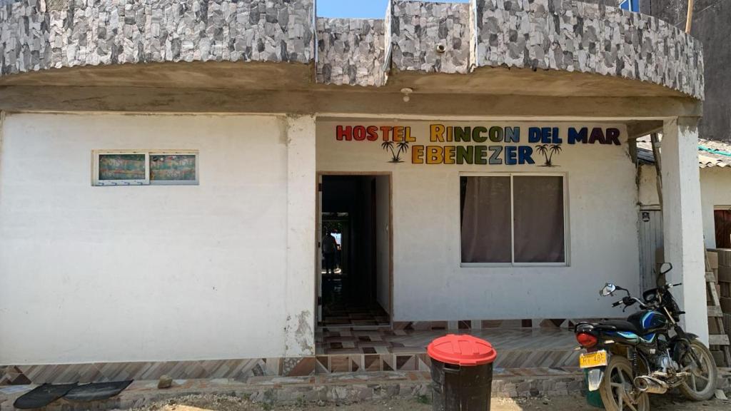 un bâtiment avec une moto garée devant lui dans l'établissement Hostel Rincon del mar Ebenezer, à San Onofre