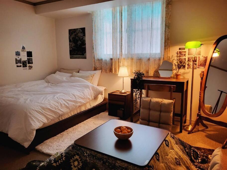 a bedroom with a bed and a table with a bowl on it at Seoul National University Apartment in Seoul