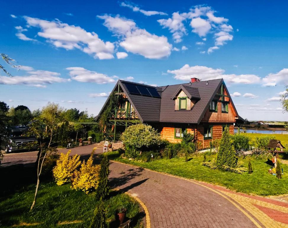 a house with solar panels on the roof at Agroturystyka Żabi Raj Serock - Pułtusk in Pokrzywnica