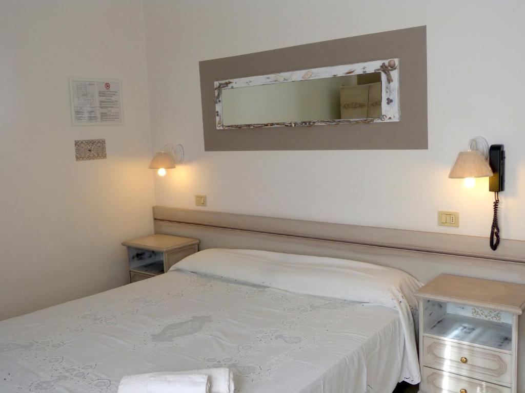 Postel nebo postele na pokoji v ubytování HOTEL D'ANNUNZIO