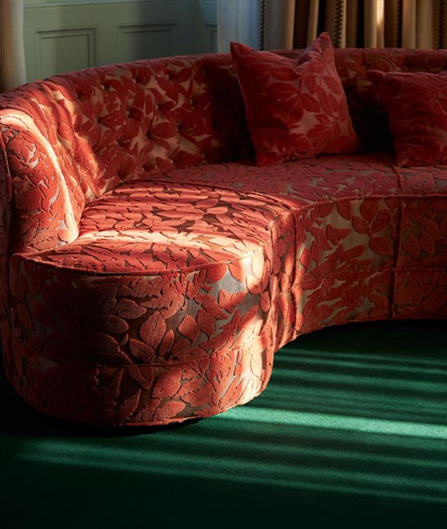 a red couch sitting in a living room at Marine North Berwick in North Berwick