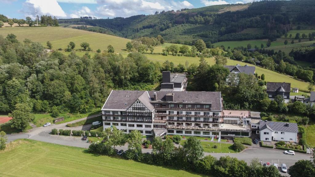 an aerial view of a large building in the mountains at Sauerland Alpin Hotel in Schmallenberg