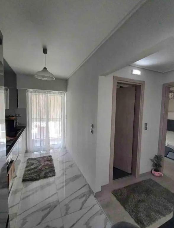 A bed or beds in a room at Lovely Faliro Apartment next to the sea.