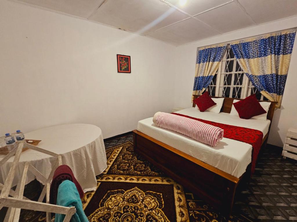 a bedroom with two beds and a window at Haven backpakers in Nuwara Eliya