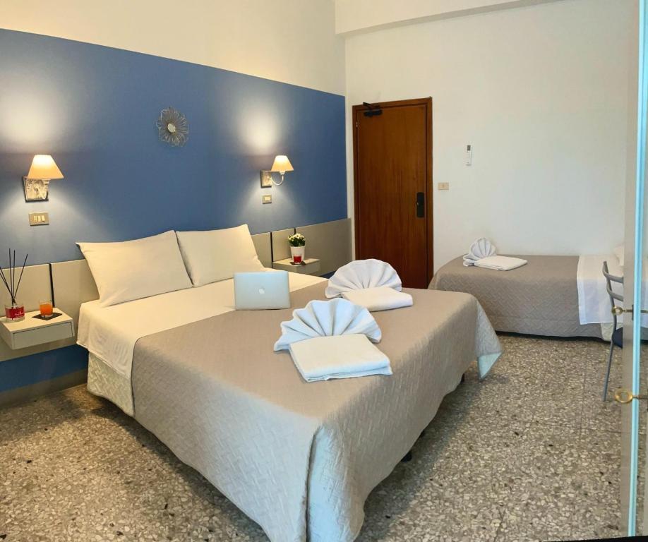 Postel nebo postele na pokoji v ubytování Hotel Alfa anche con SPIAGGIA INCLUSA