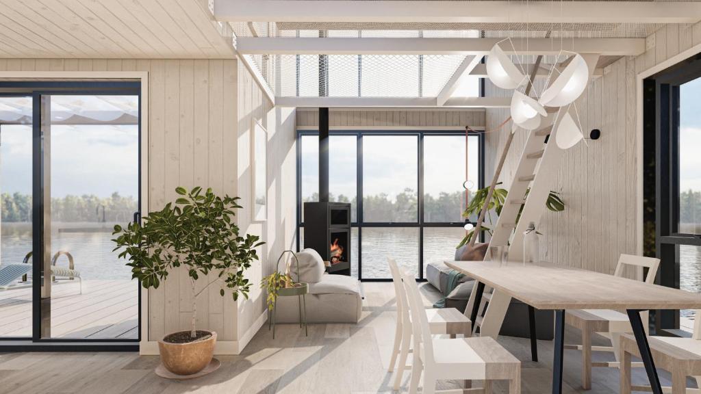 a living room with a table and chairs and a view of the water at BoraVilla - La brume - Cantons-de-l'Est in Bury