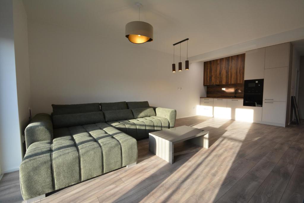 a living room with a couch and a table at Project IK luxury apartments in Seredʼ