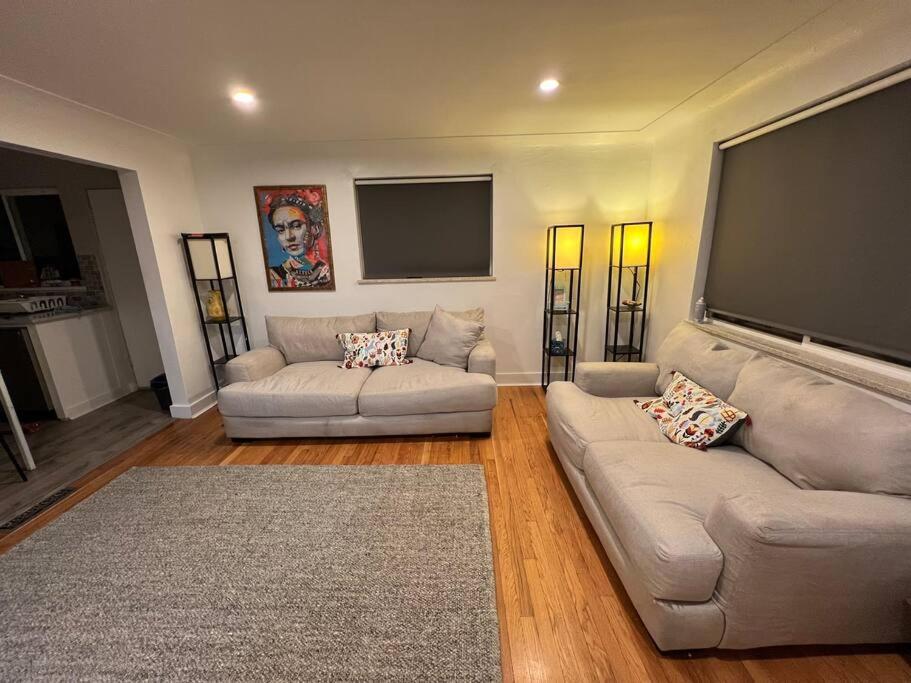 a living room with two couches and a flat screen tv at 2 bedroom in Denver, Centralized in Denver