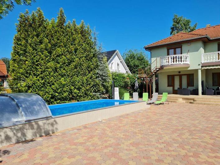 a swimming pool in the backyard of a house at Green Garden Apartments in Siófok