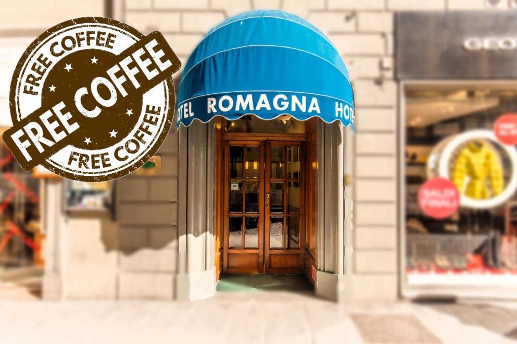 a coffee shop with a blue awning on a building at Hotel Romagna in Florence