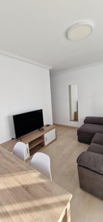A television and/or entertainment centre at Apartamentos Gran Socaire de Noja