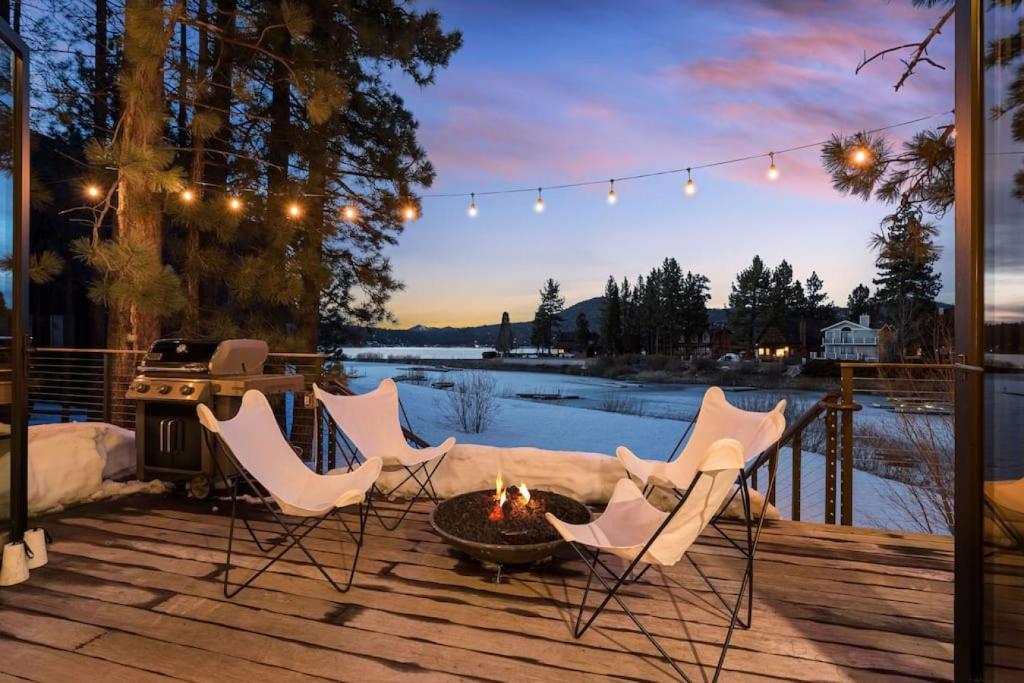 a patio with chairs and a fire pit on a deck at Mountain Top Modern Lakefront in Sunset Magazine in Big Bear Lake