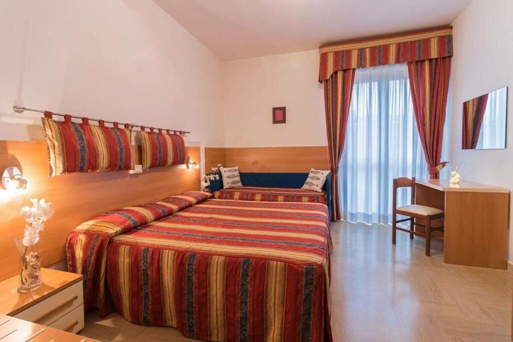 Postel nebo postele na pokoji v ubytování Hotel Corallo