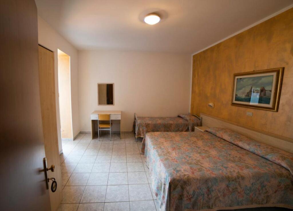 Postel nebo postele na pokoji v ubytování Hotel Corallo