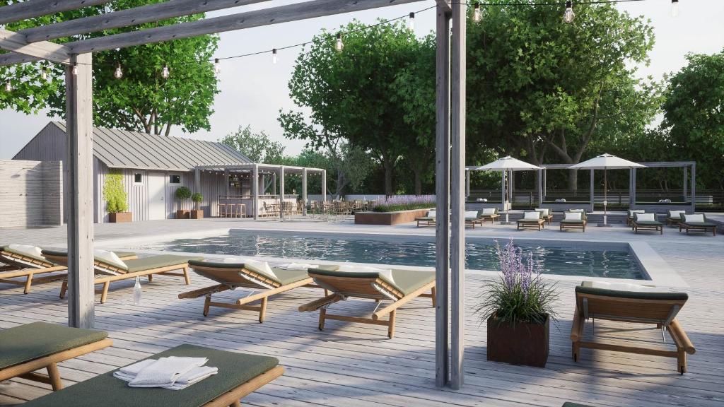 a swimming pool with lounge chairs and a swimming pool at Gumbalde Resort in Stånga
