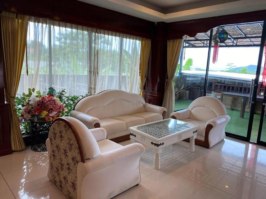 a living room with two chairs and a coffee table at Phuket Private Pool and Thai Villa Style by Andaman Home in Phuket Town