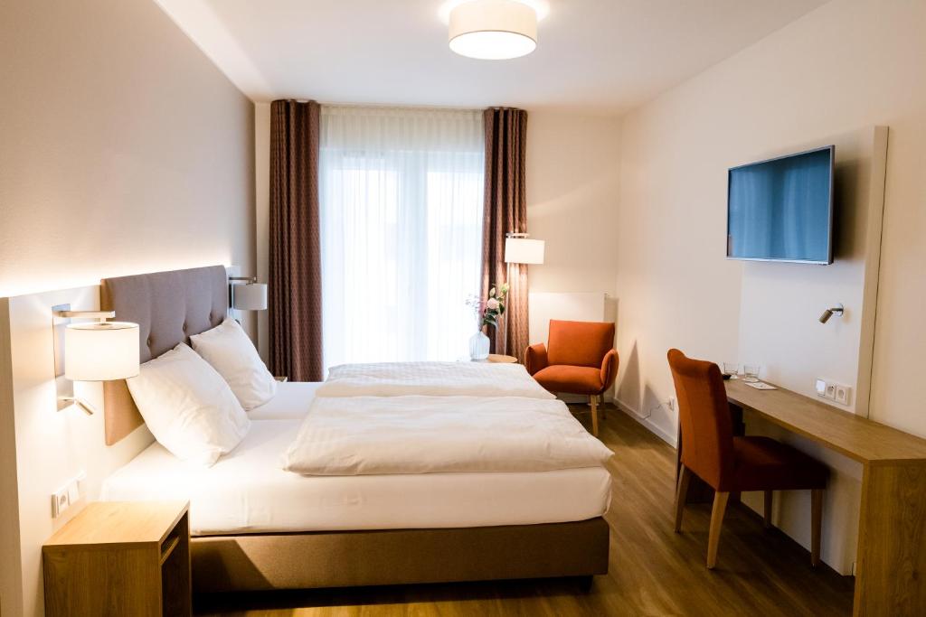 een hotelkamer met een bed en een bureau bij Haus Rissen Gaestehaus in Hamburg