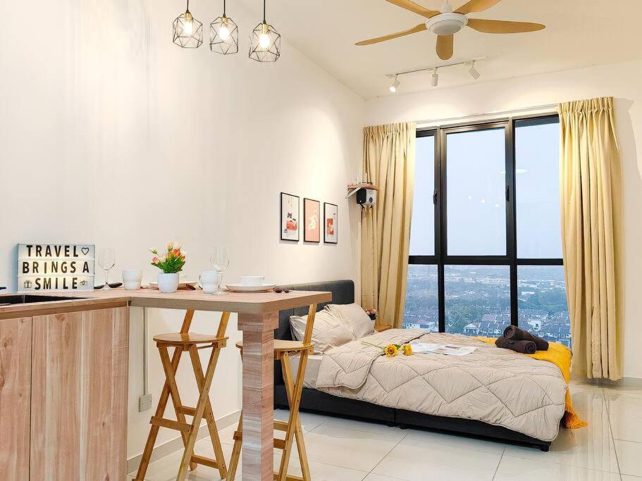 a bedroom with a bed and a desk with a table at Bukit Indah 1/Studio/Aeon Mall in Johor Bahru