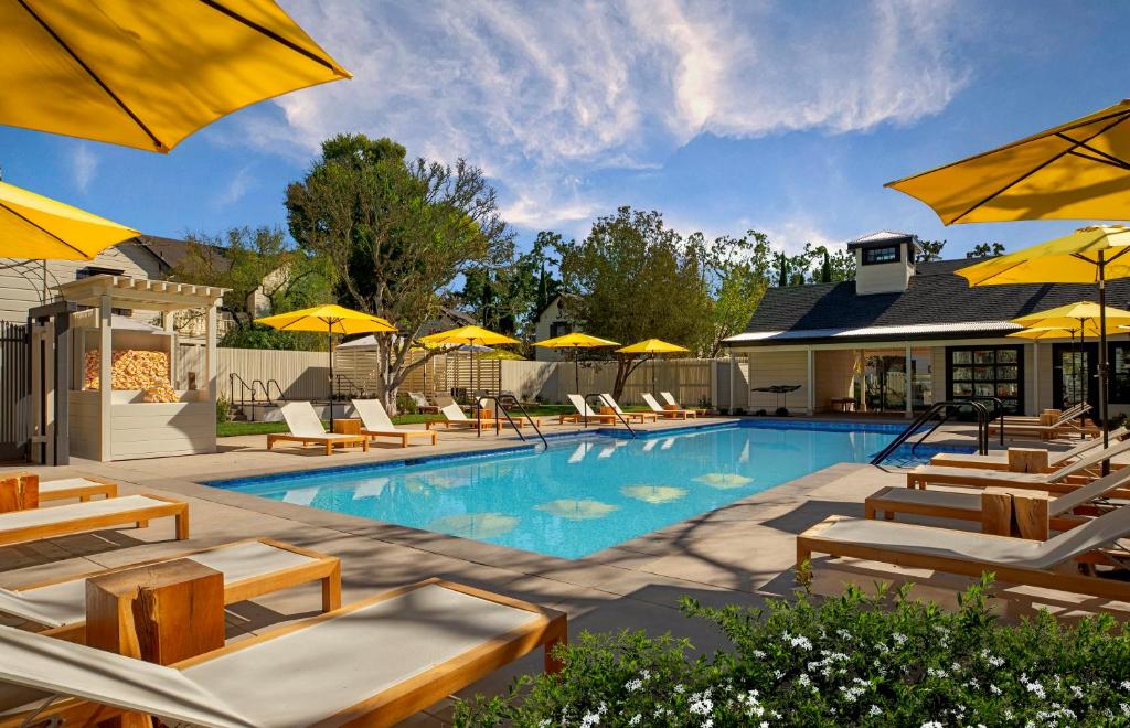 a swimming pool with chairs and umbrellas at MacArthur Place Inn & Spa in Sonoma