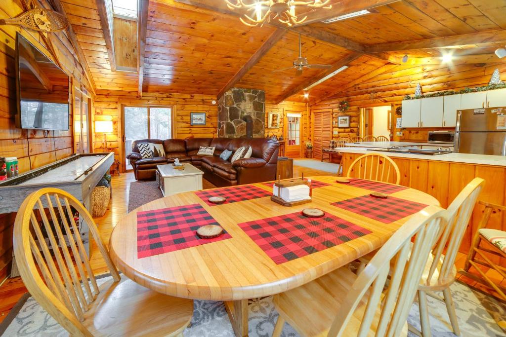 a dining room and kitchen with a table and chairs at Three Bears Cabin btwn Mt Snow and Stratton Mtn! in Wardsboro