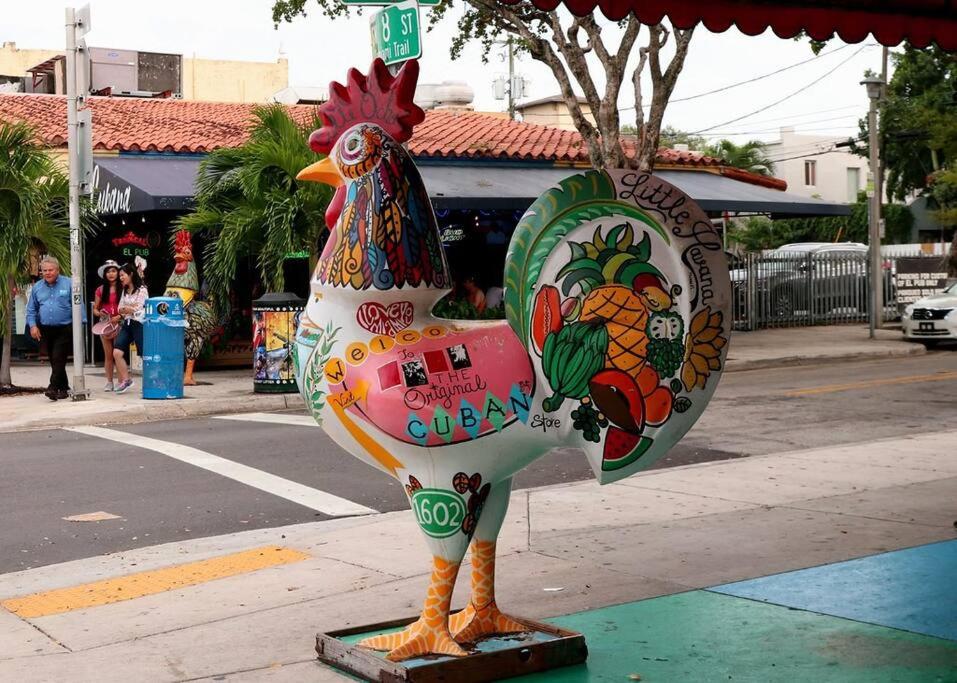 a statue of a chicken sitting on a sidewalk at Prime Location Apt on Calle Ocho in Little Havana in Miami