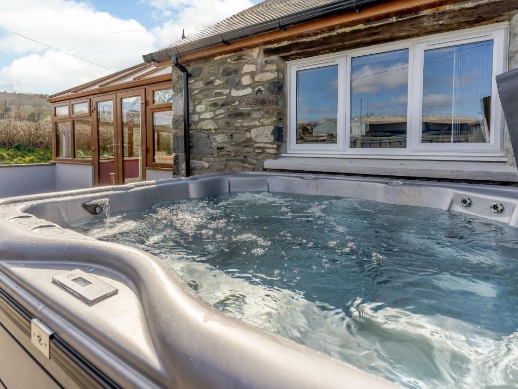 a hot tub in front of a house at 3 Bed in Lampeter 86506 in Cellan