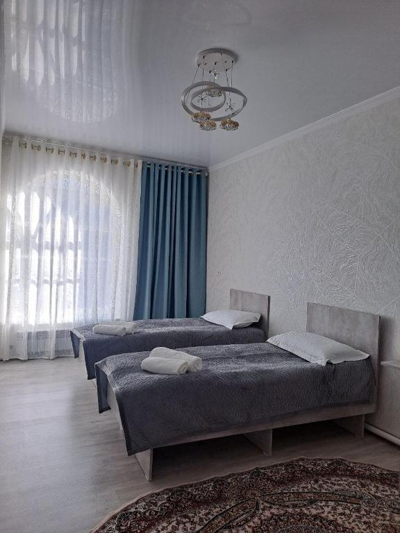 Postel nebo postele na pokoji v ubytování GuestHouse "ERKIN"