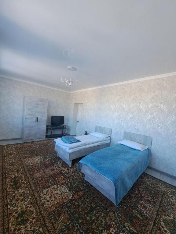 Postel nebo postele na pokoji v ubytování GuestHouse "ERKIN"
