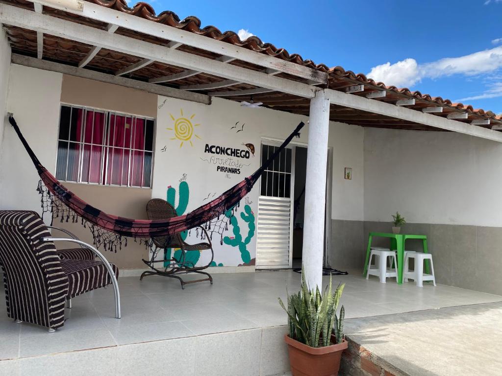 a patio with a hammock on the side of a house at Casa em Piranhas Aconchego in Piranhas