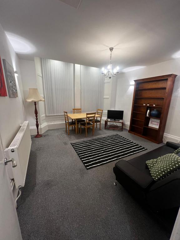 a living room with a table and a dining room at No 2 at Mannering, Large 1 bed near Lark Lane in Liverpool