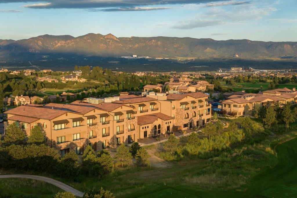 an aerial view of a building with mountains in the background at The Lodge at Flying Horse in Colorado Springs
