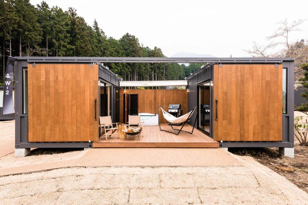 a modular house with wooden doors and a deck at Gotemba City - Camp - Vacation STAY 42083v in Gotemba