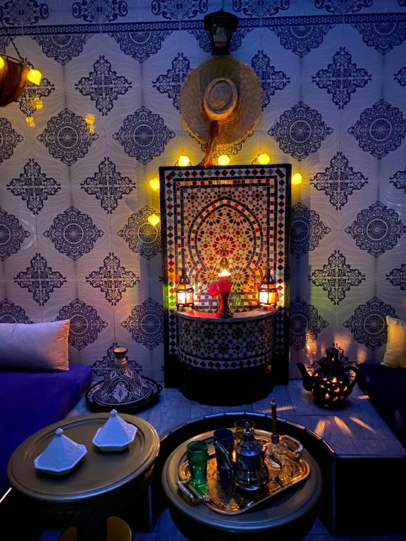 a room with a table with candles and a wall at Dar El Yacout in Rabat